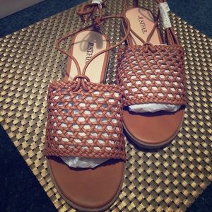 Brown basket weave lace up flats.